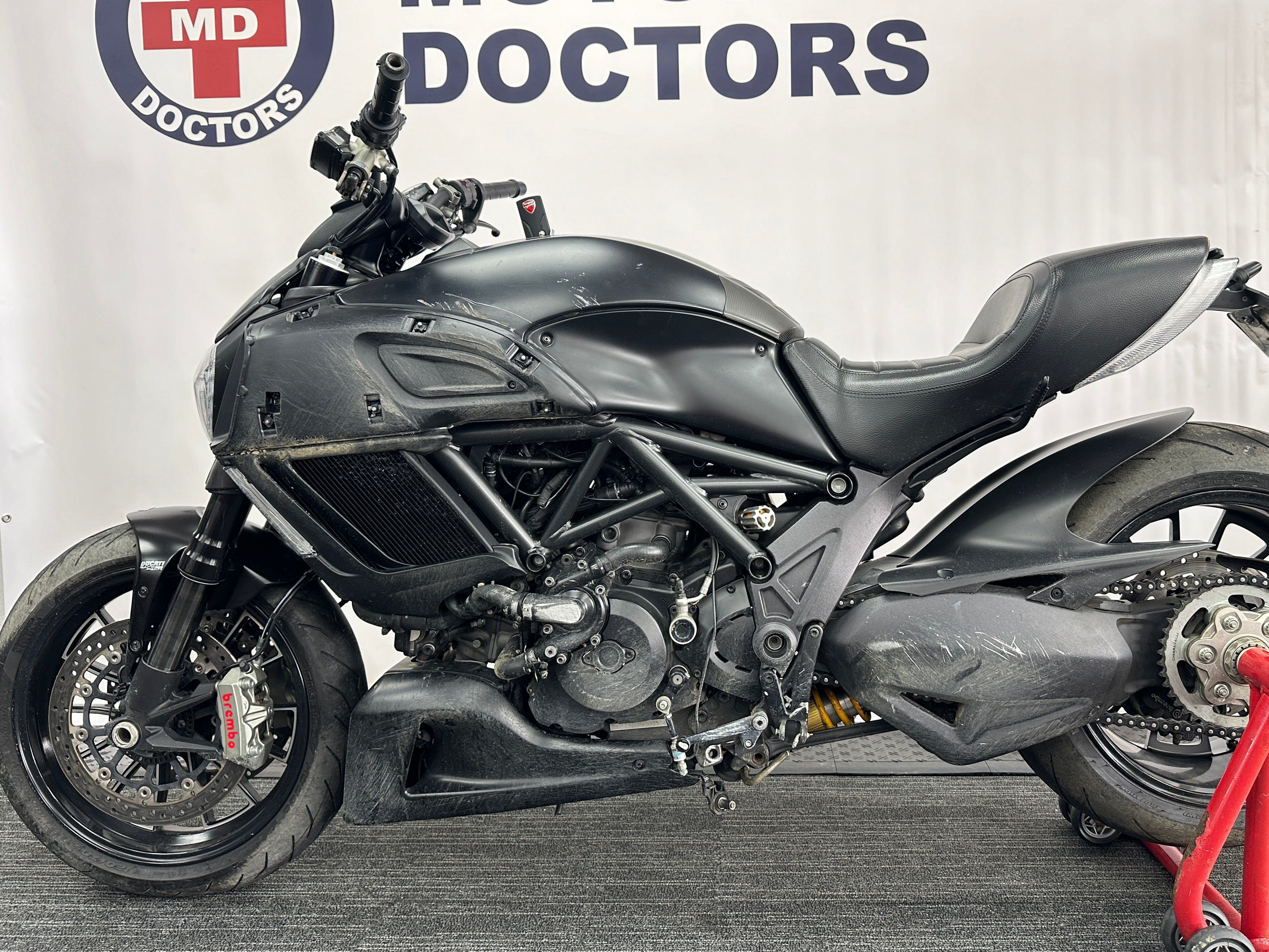 Motorcycle Doctors technicians performing collision and crash repairs on a motorcycle at their Auckland workshop