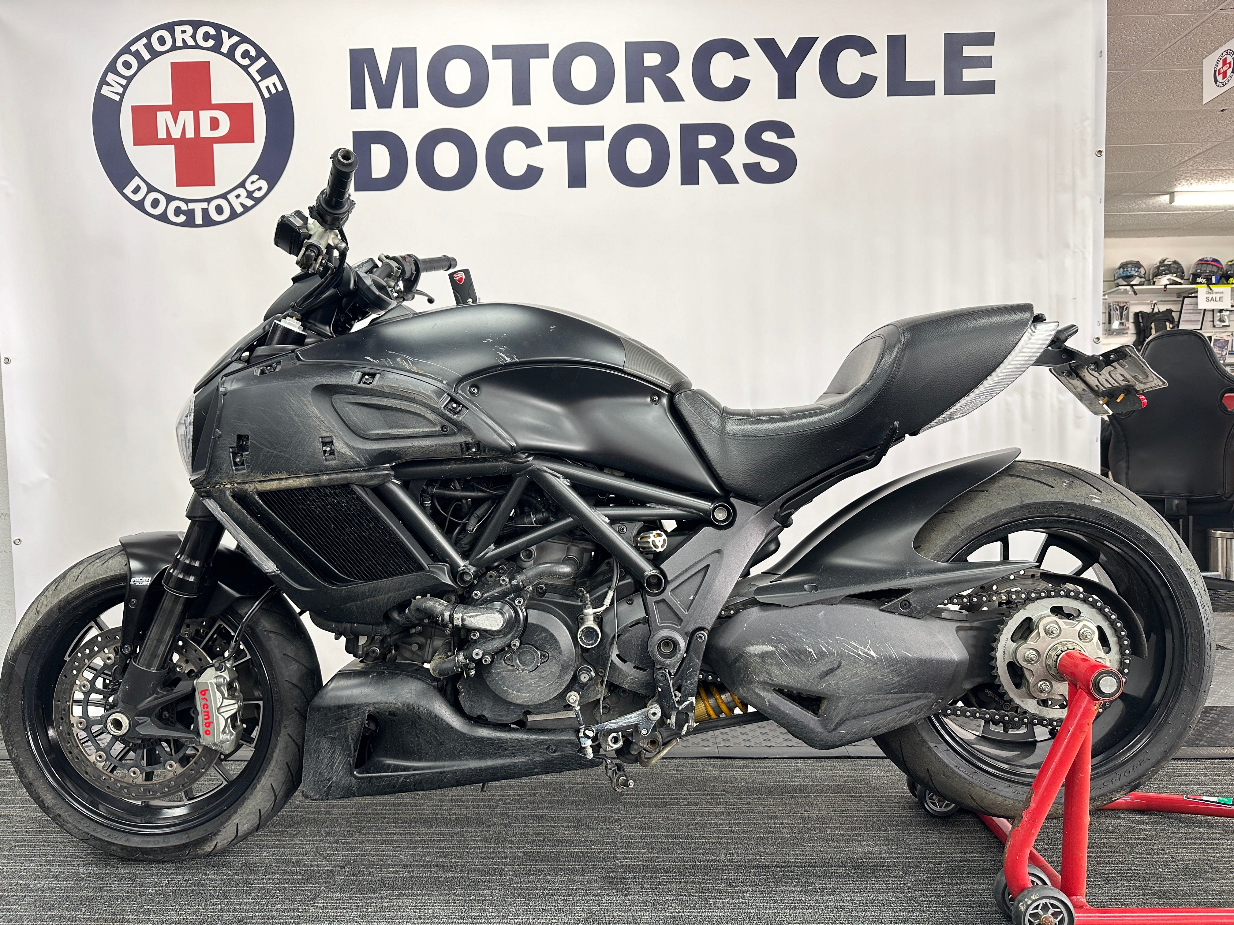 Motorcycle Doctors technicians performing collision and crash repairs on a motorcycle at their Auckland workshop