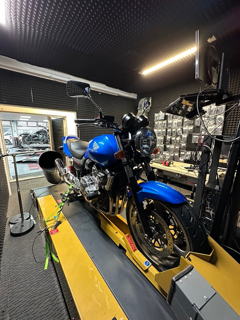 Motorcycle Doctors technician performing ECU mapping and dyno performance tuning on a motorcycle in their Auckland workshop