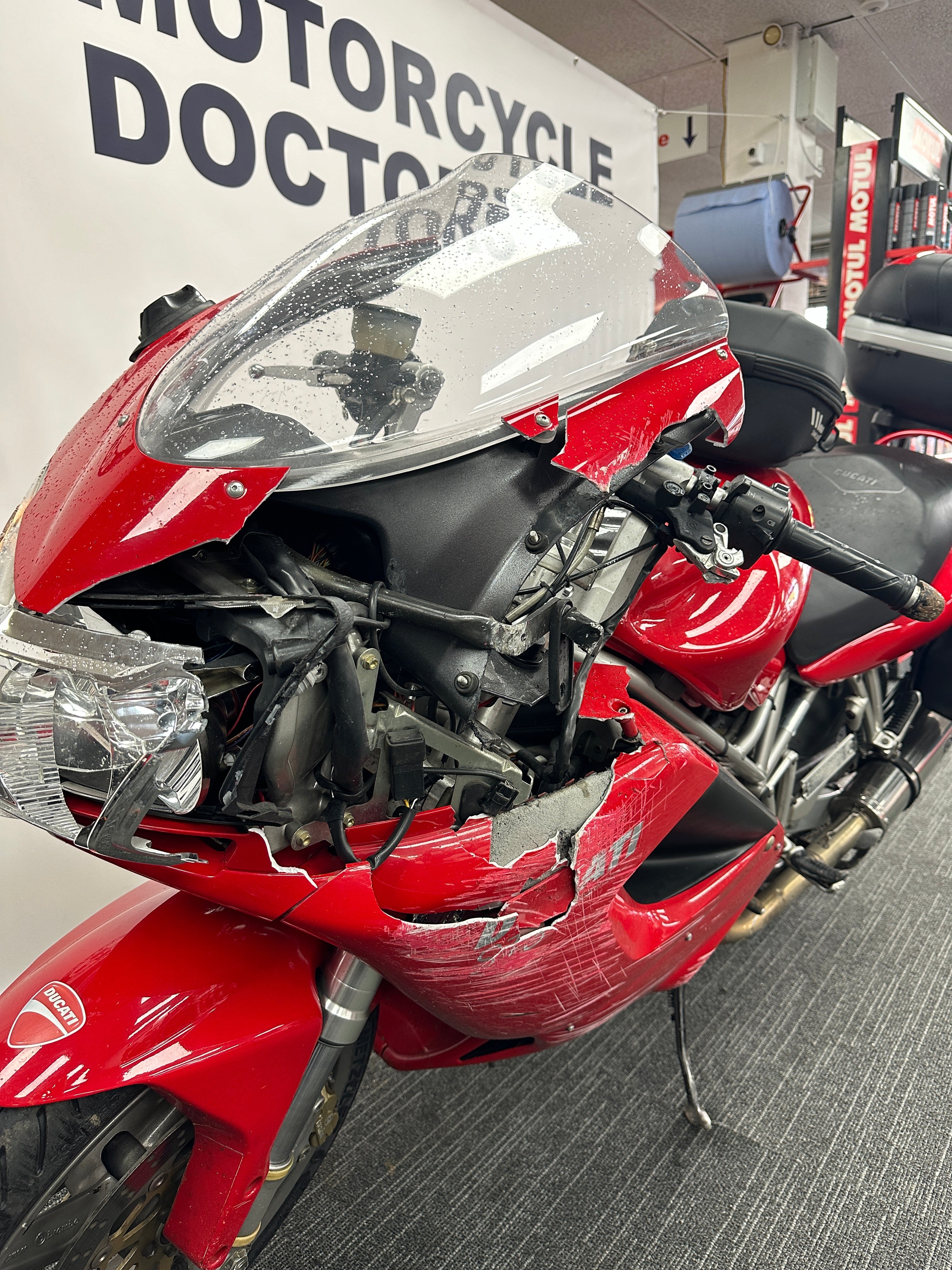 Motorcycle Doctors technicians performing insurance collision and crash repairs on a motorcycle at their Auckland workshop