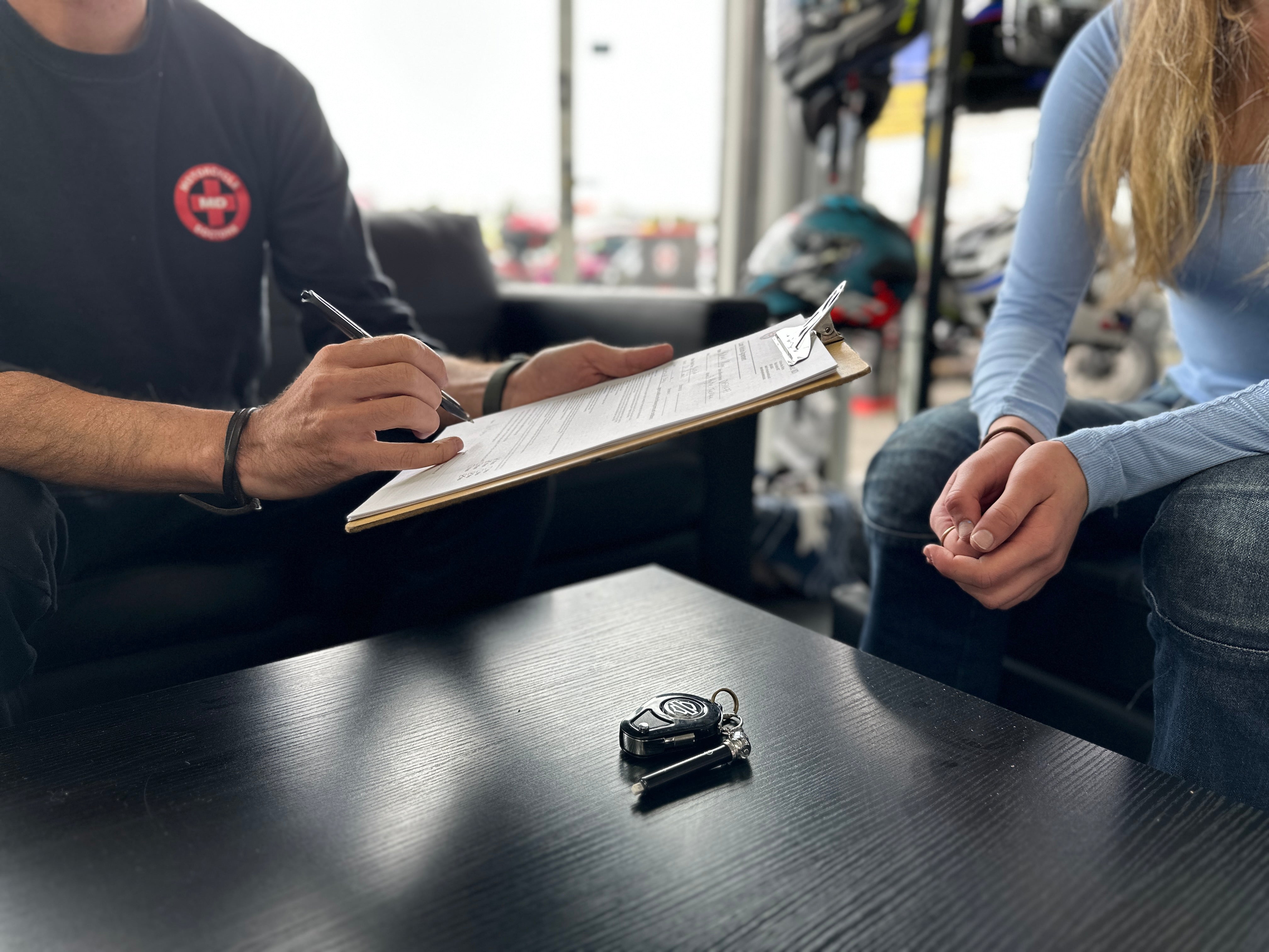 Staff processing a motorcycle crash repair insurance claim at Motorcycle Doctors workshop in Auckland