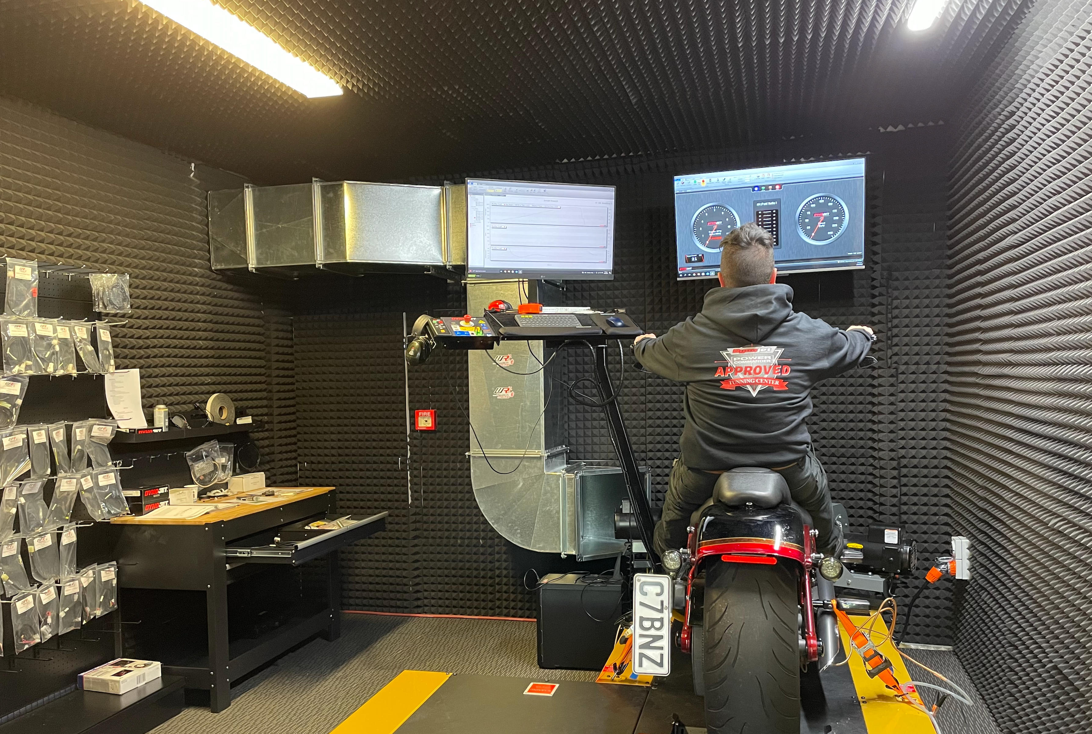 Motorcycle Doctors technician monitoring dyno tuning performance data on screen while a motorcycle runs on the dyno, exemplifying quality you can trust